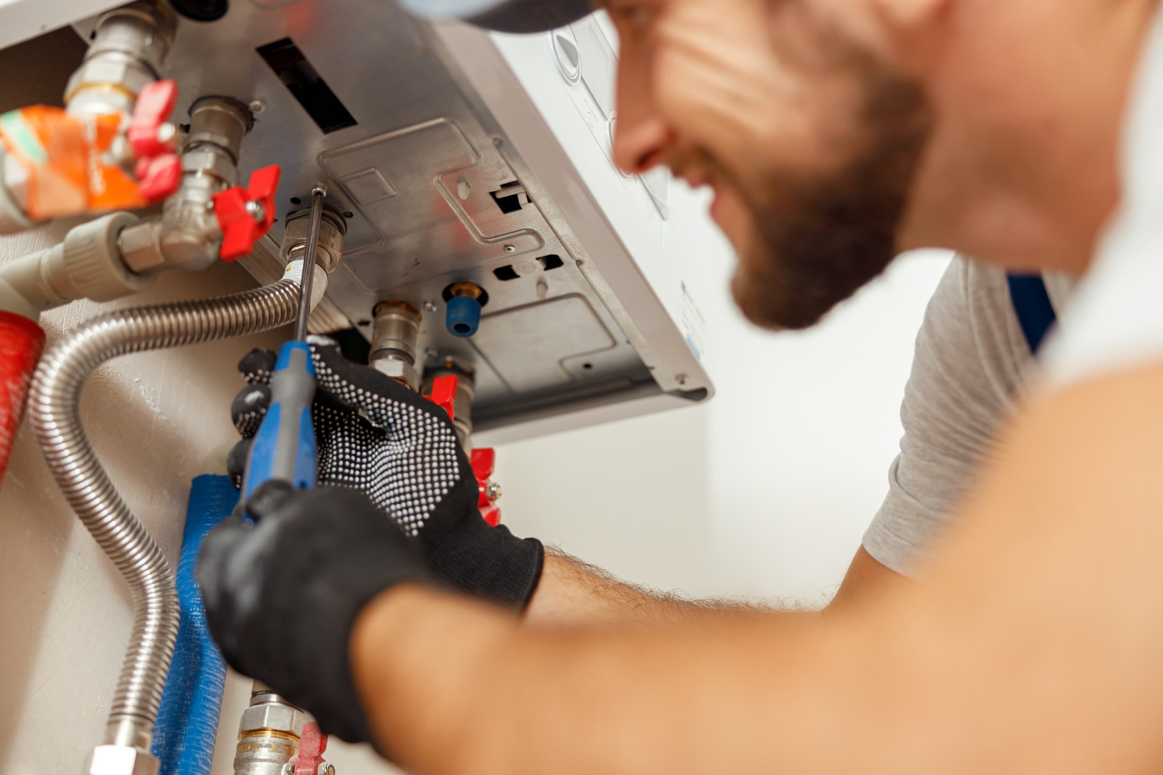 Technician installing water filtration equipment